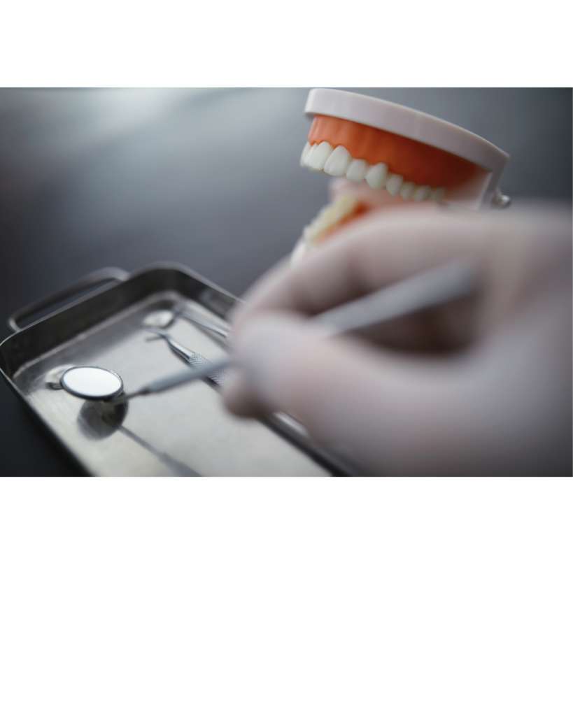 Close up image of someone holding a dental mirror