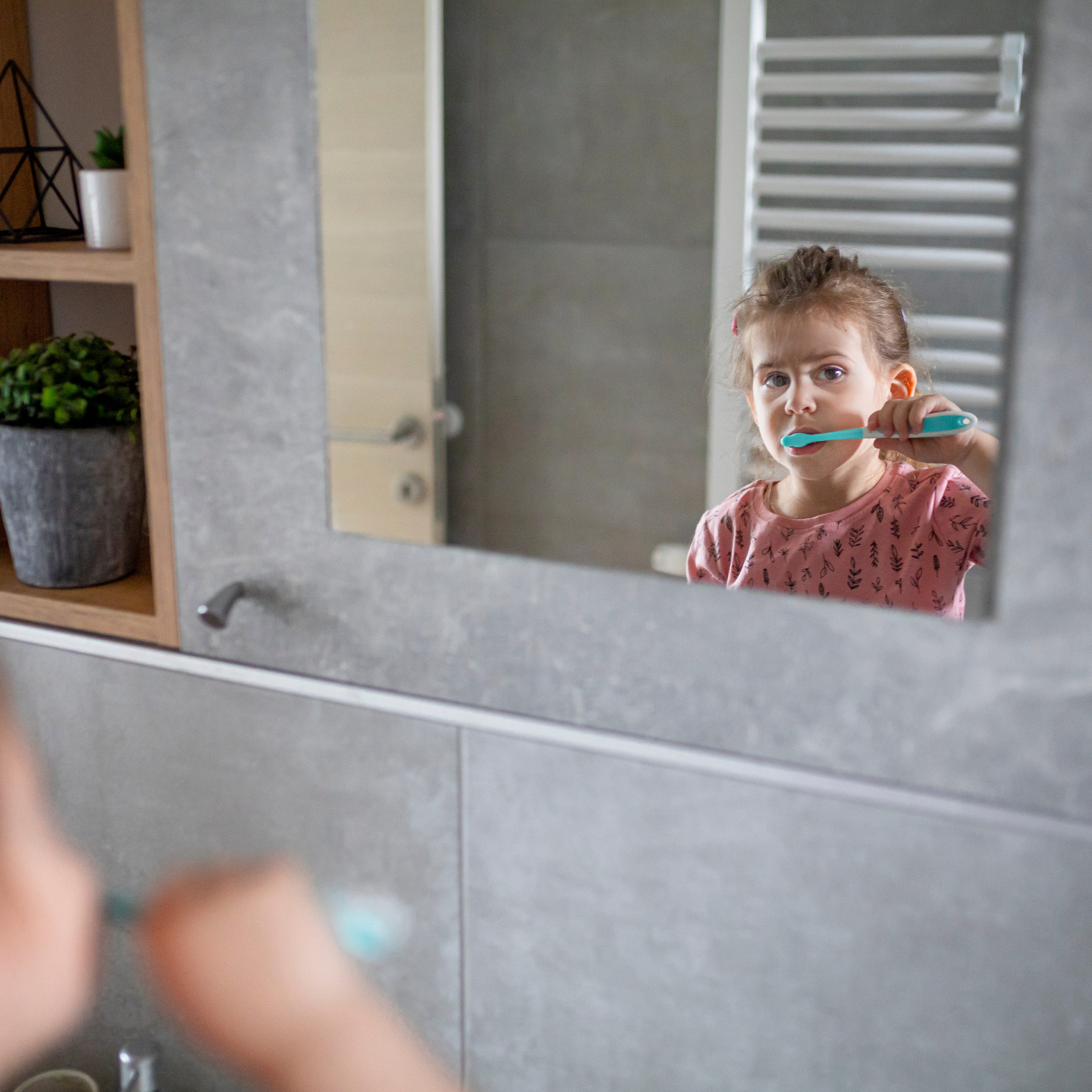 Hygiene child brushing teeth in mirror